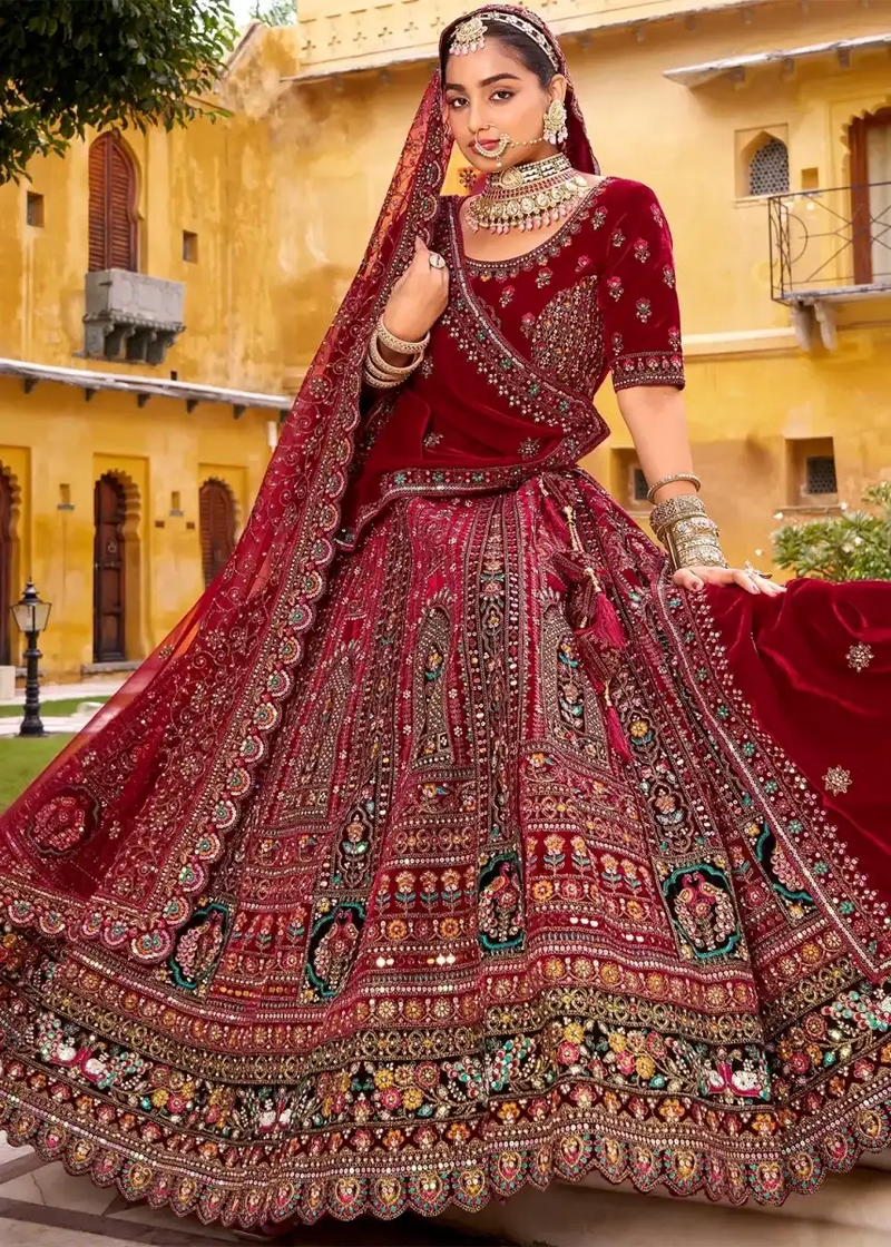 Maroon velvet bridal lehenga with ornate multi-thread embroidery and flared skirt