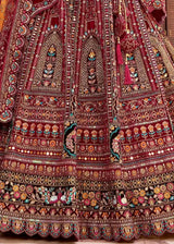 Maroon velvet lehenga skirt close-up with dense multicolor embroidered motifs