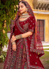 Maroon bridal lehenga with ornate mirror-work embroidery and draped dupatta
