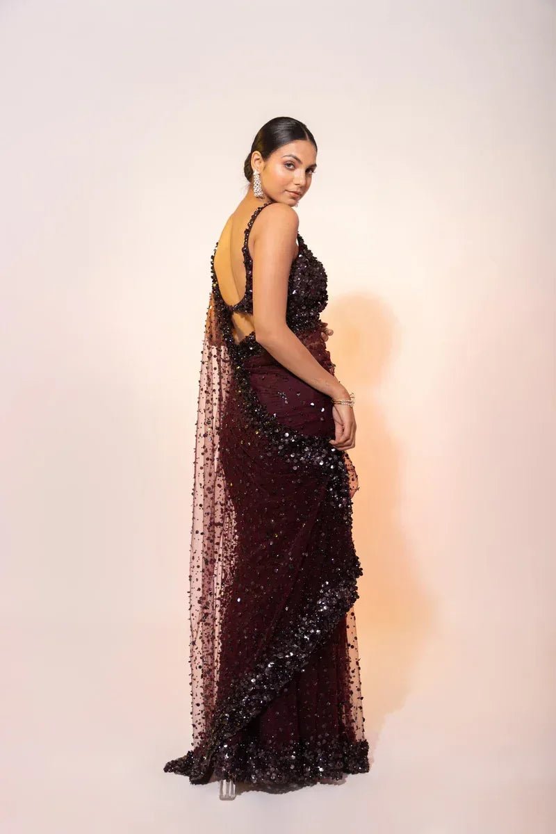 Deep wine hologram sequin cocktail saree with sleeveless neckline and sheer net drape