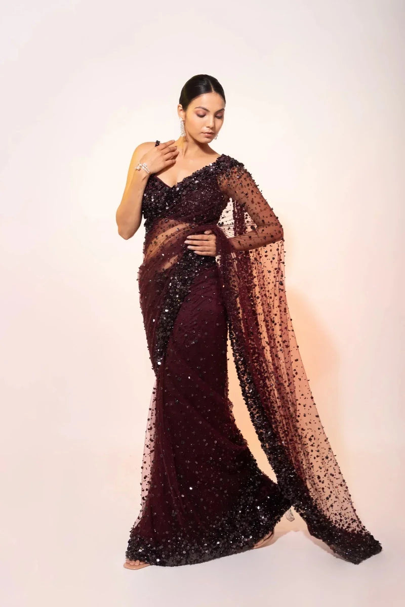 Deep wine sequin net cocktail saree with draped sheer tail and sparkling body