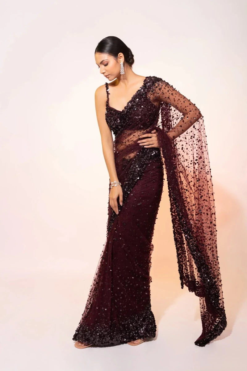 Deep wine sequin net cocktail saree with fitted silhouette and trailing sheer net