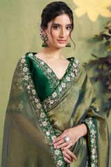Dusty olive glass tissue saree with ornate floral neckline and embellished border