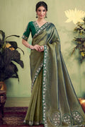 Dusty olive saree with gold sheen and floral border, draped with long pallu