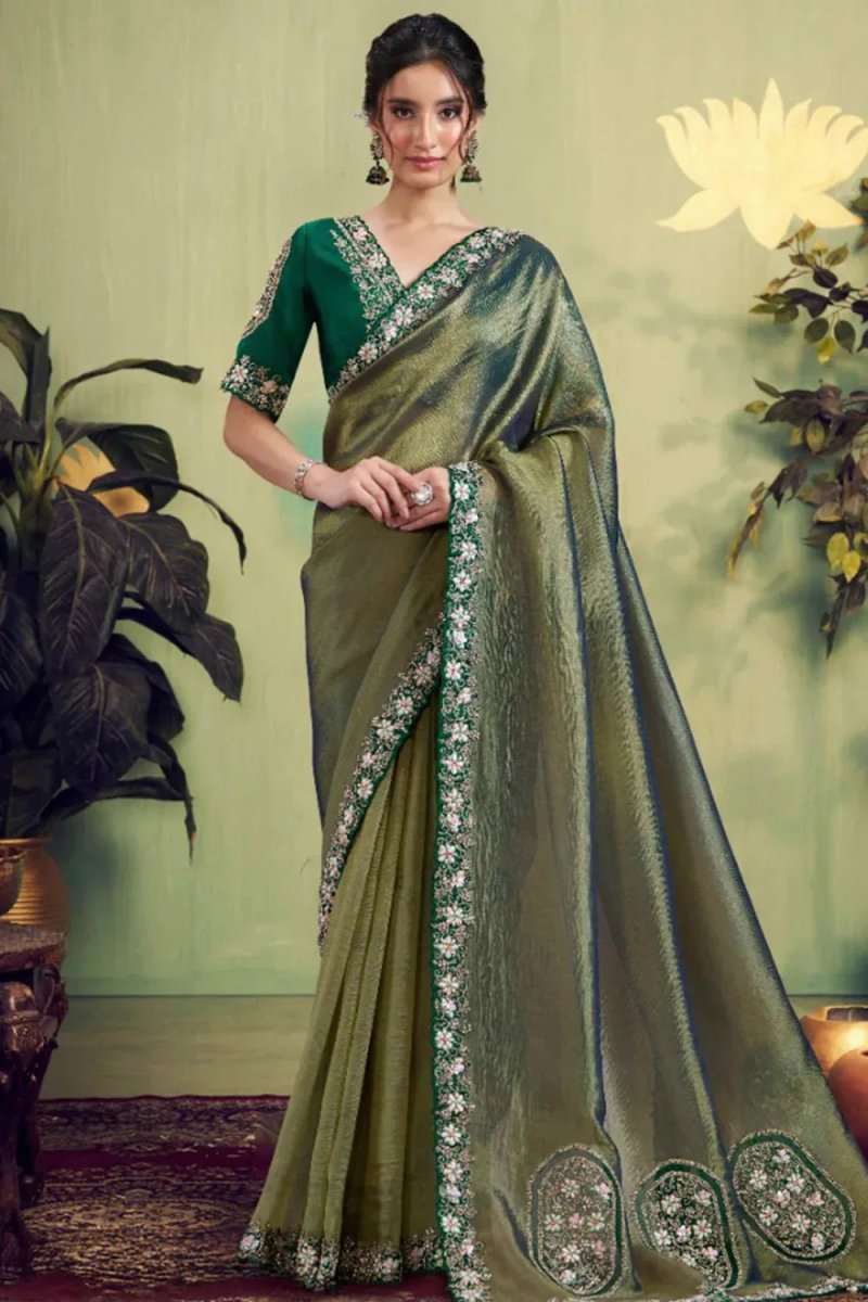 Dusty olive saree with gold sheen and floral border, draped with long pallu