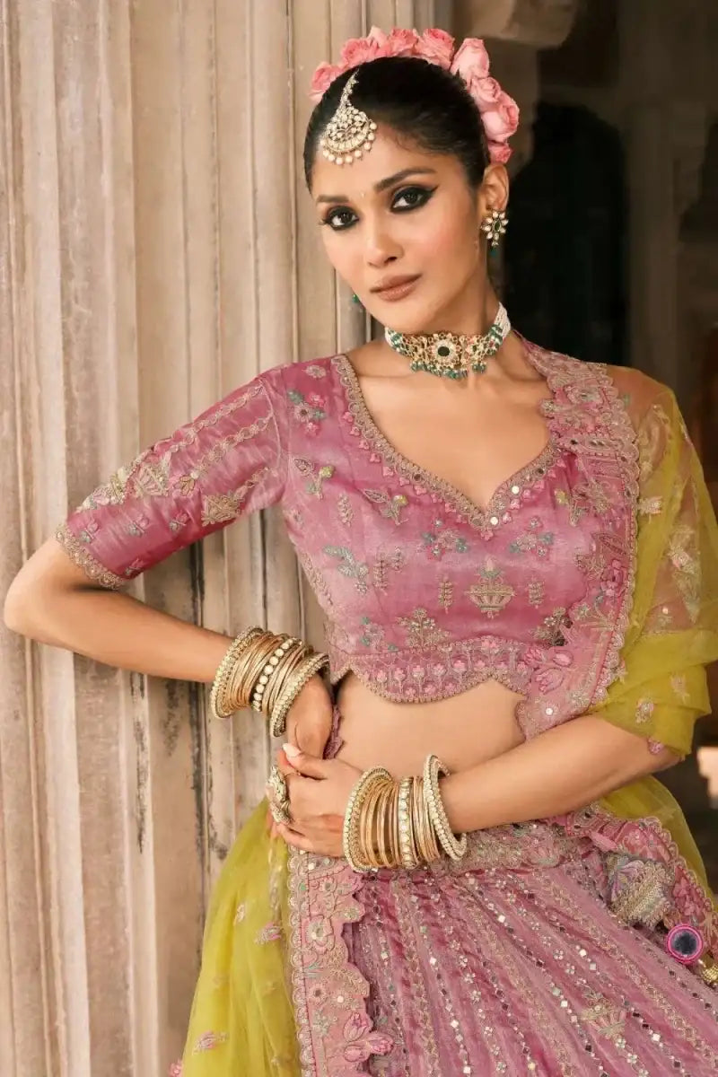 Embroidered pink lehenga blouse with floral motifs, matching ombre skirt and bangles