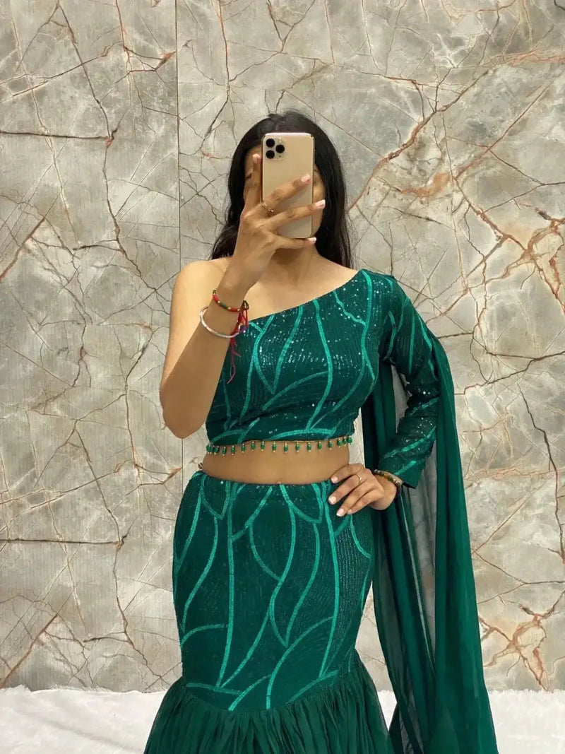 Emerald green western lehenga set with embellished off-shoulder blouse and tiered skirt