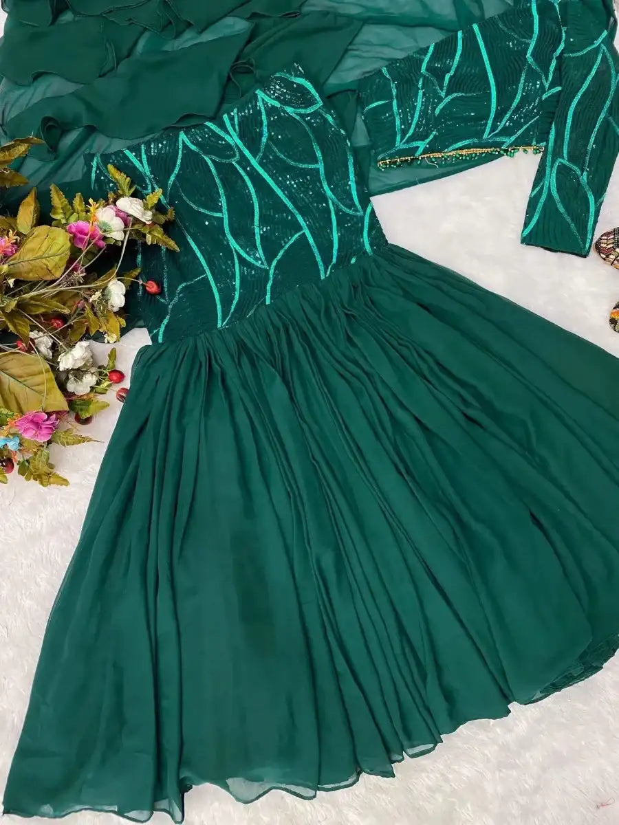 Emerald green tiered lehenga skirt with shimmering pattern and trim