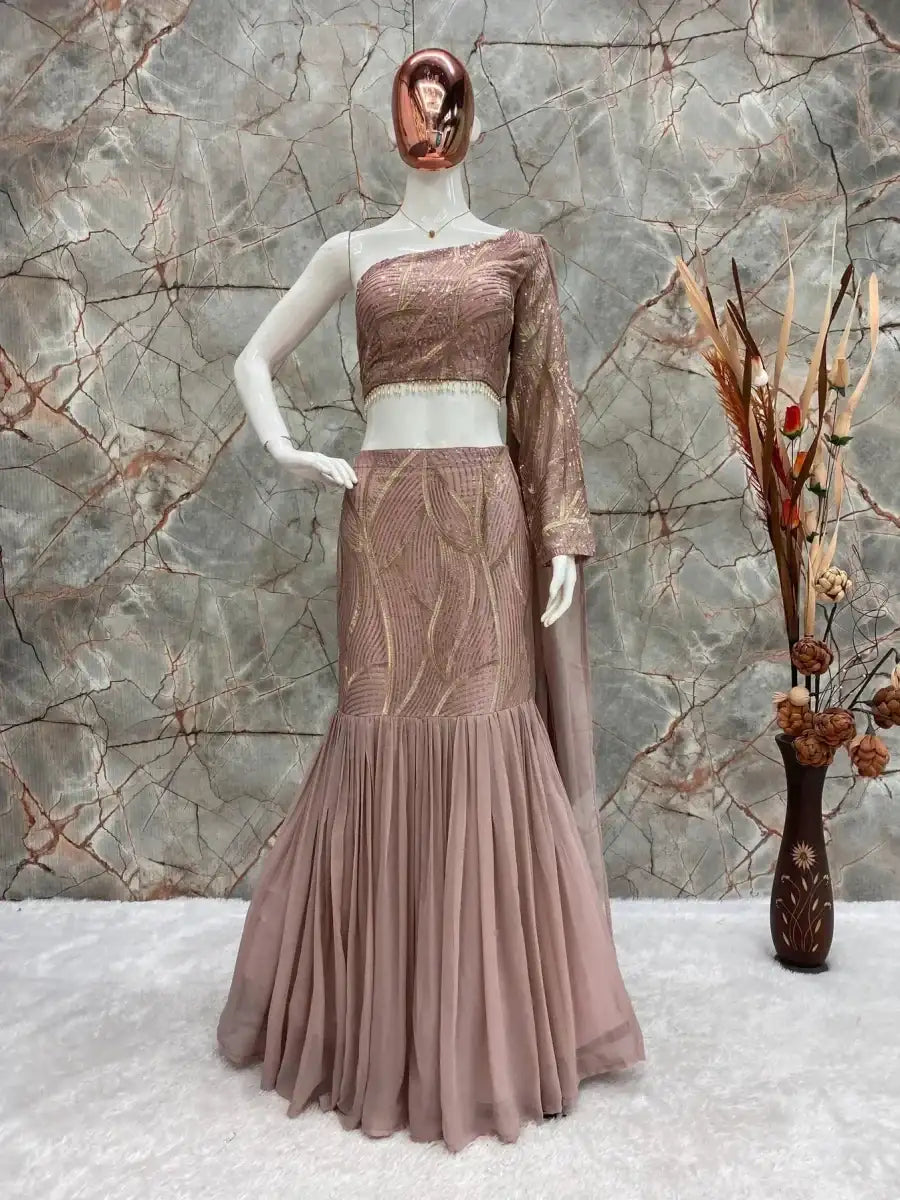 Blush rose lehenga set with metallic bodice, long sleeves, and tiered skirt