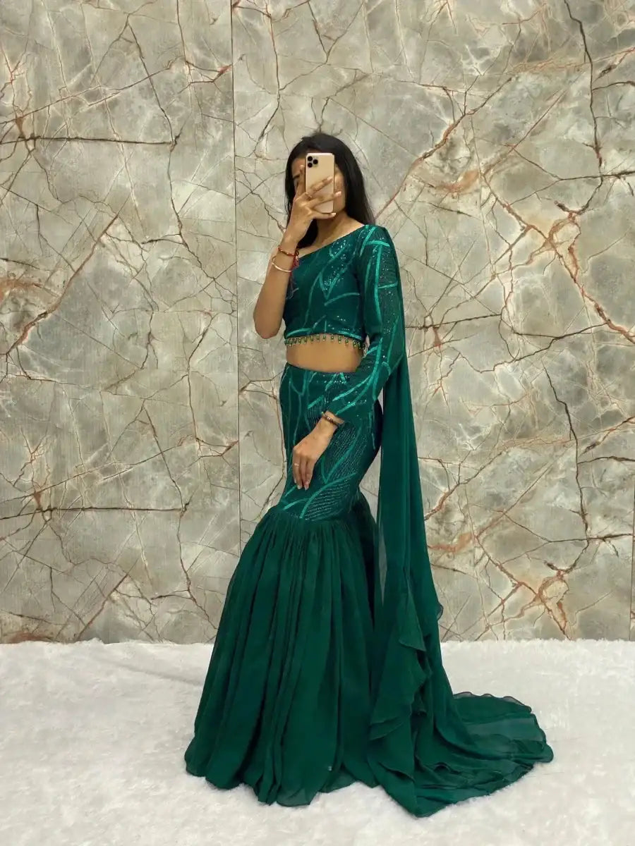 Emerald green lehenga set: cropped top, tiered skirt, and matching dupatta