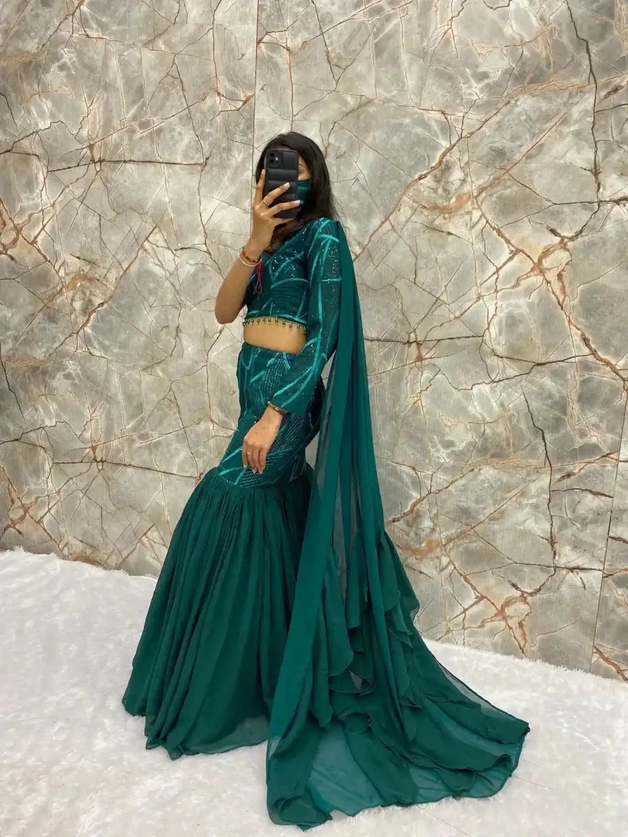 Emerald green lehenga set with cropped top, tiered skirt, and long draped dupatta