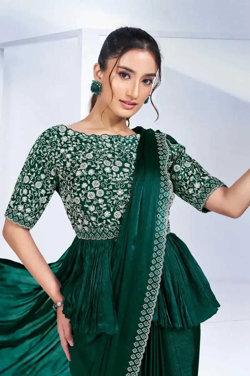 Dark green embroidered peplum drape saree with floral bodice and drape over shoulder