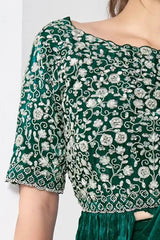 Embroidered peplum drape saree in dark green with floral motifs on sleeves