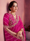 Fuchsia pink leheriya satin saree with gold embroidered V-neck blouse, puff sleeves
