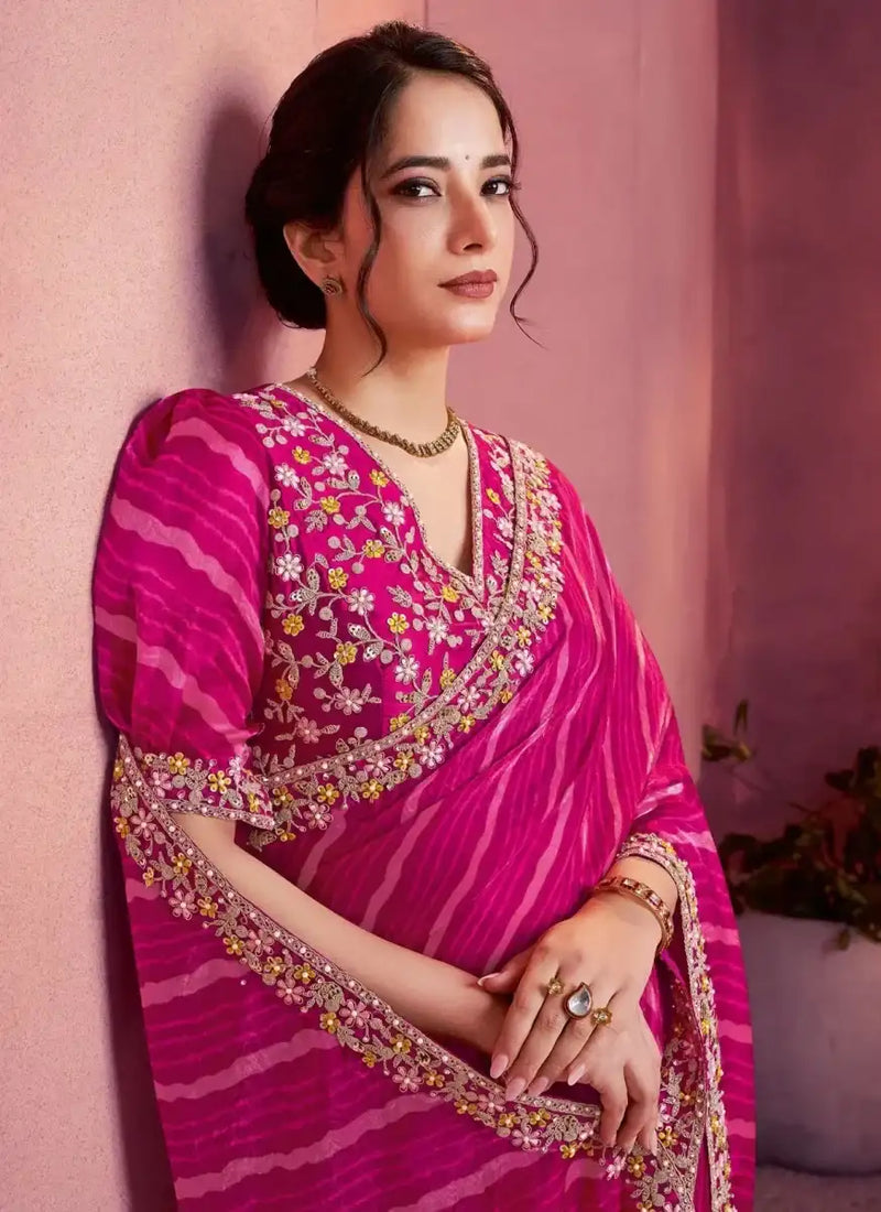 Fuchsia pink satin saree with leheriya wave pattern and floral-gold border; puff sleeves blouse