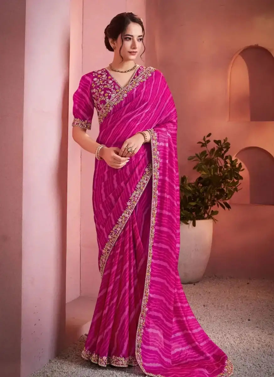 Fuchsia pink leheriya satin saree with gold border and embroidered puff-sleeve blouse