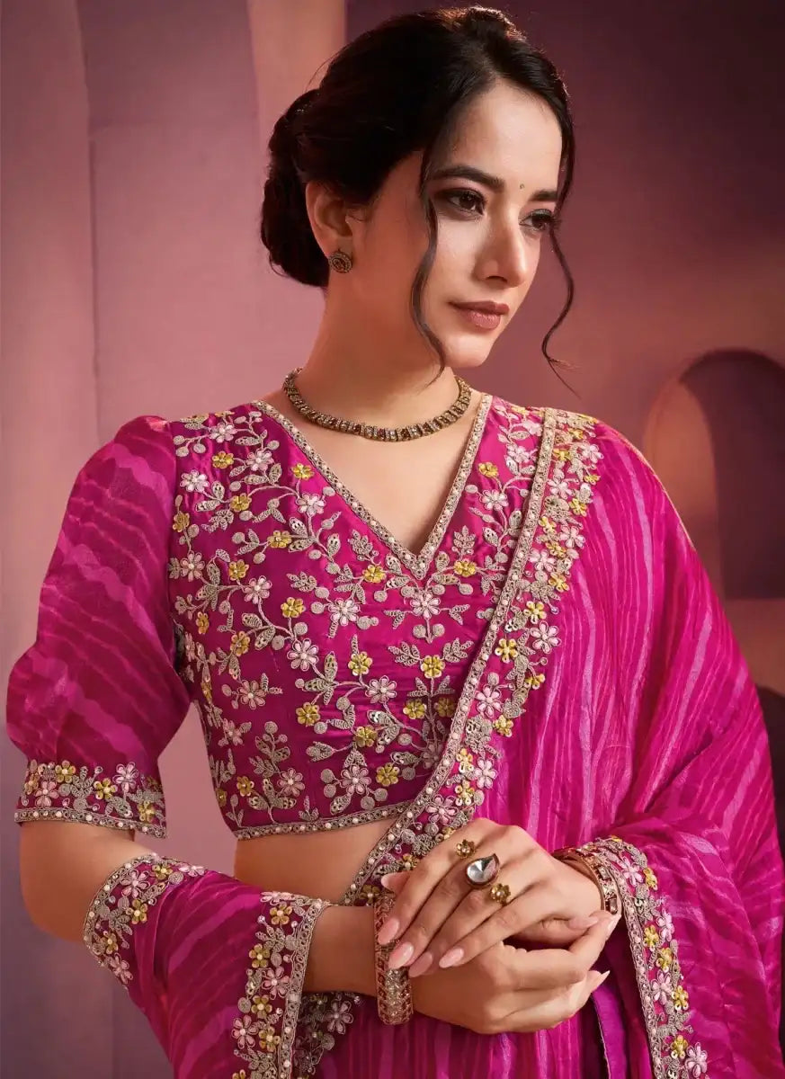 Fuchsia pink leheriya saree with gold embroidered blouse, V-neck and puff sleeves