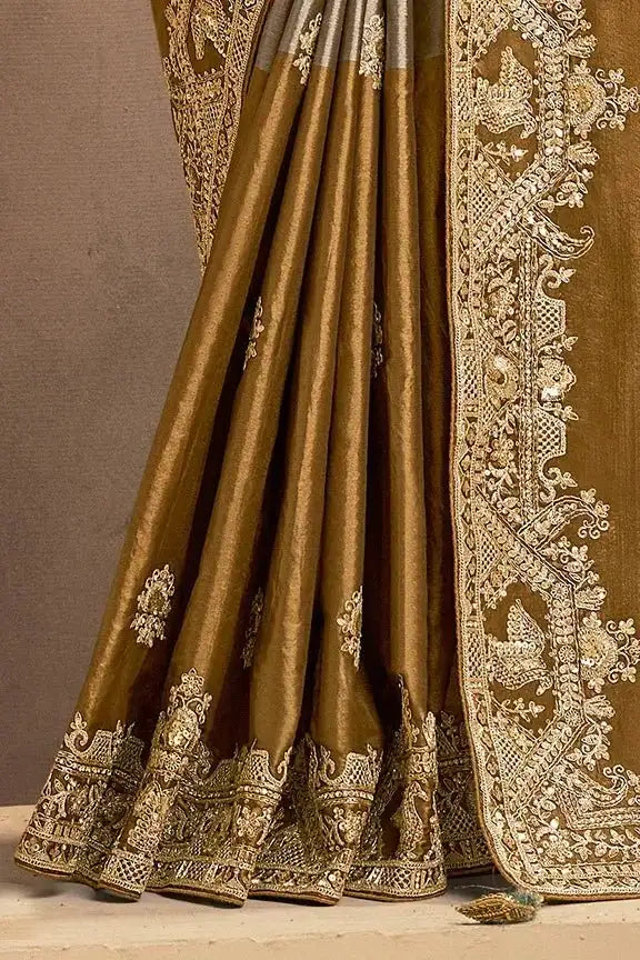 Grey-bronze silk saree with gold embroidered skirt hem and floral motifs