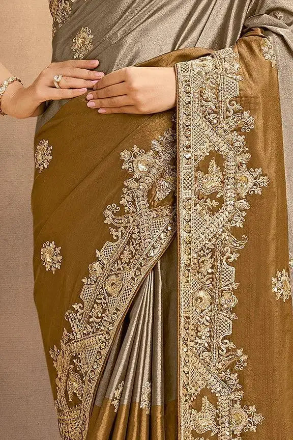 Grey-bronze silk saree with heavy gold zari-style embroidery along border