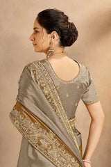 Grey bronze silk saree with gold embroidered side border and back drape