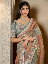 Grey-teal tissue silk saree with multicolor floral embroidery and bronze scalloped border