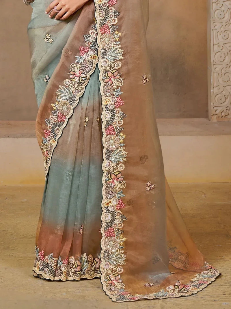 Grey-teal saree with long bronze scalloped embroidered border, pleated hem detail