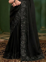 Black embroidered georgette silk saree with vertical decorative border on the skirt