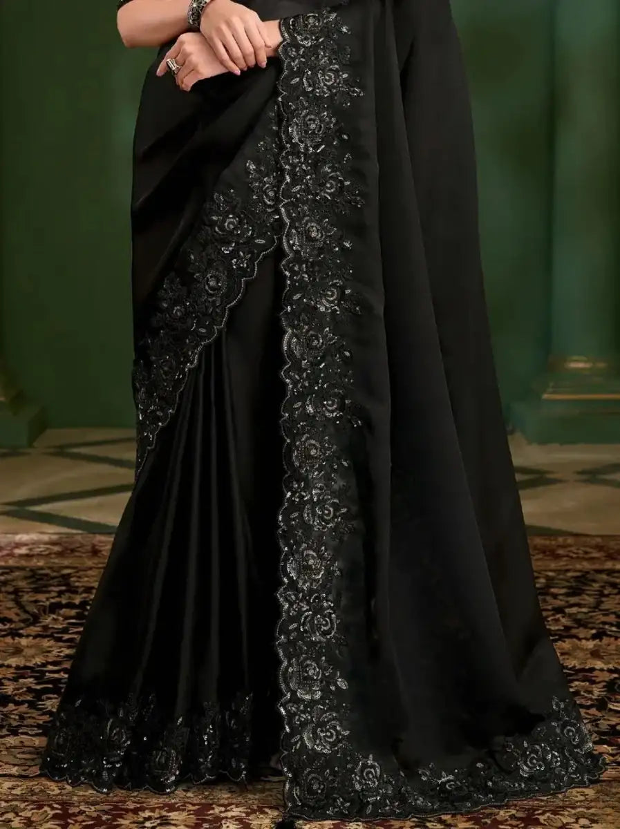 Black georgette silk saree with long embroidered center panel and flowing pallu