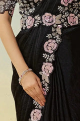 Black satin saree set with pink rose embroidered trim and beaded bracelet