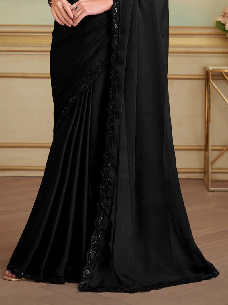 Black saree with scalloped lace border and pleated drape, side view