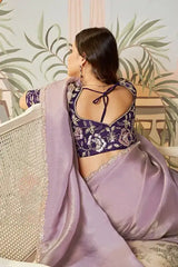 Lavender saree with gold trim; dark contrast blouse open-back tie detail