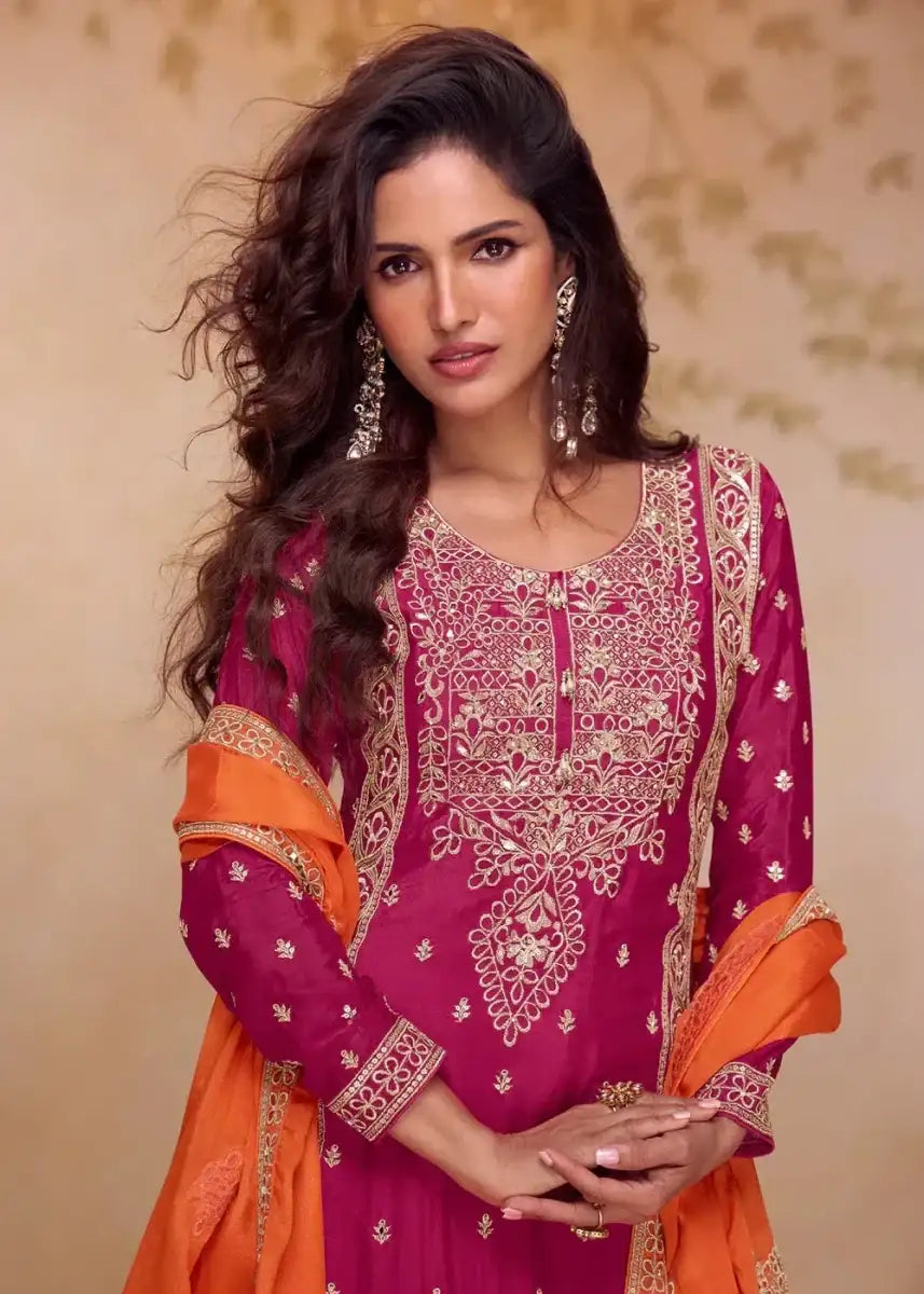 Magenta A-line palazzo suit with embroidered neckline and cuffs, orange dupatta