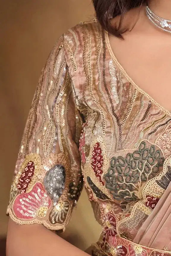 Close-up of champagne beige saree sleeve and neckline with sequin embroidery