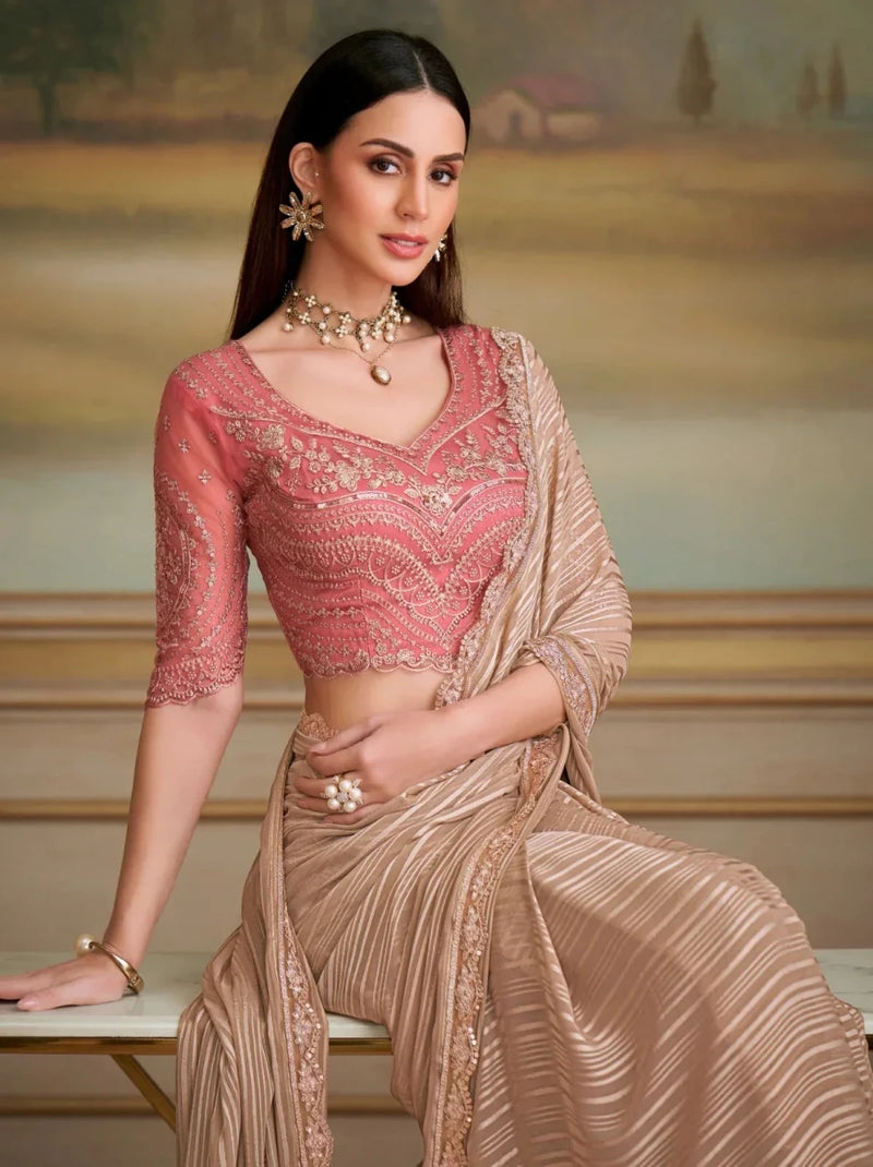 Metallic champagne striped saree with pink 3/4-sleeve blouse, pallu over shoulder
