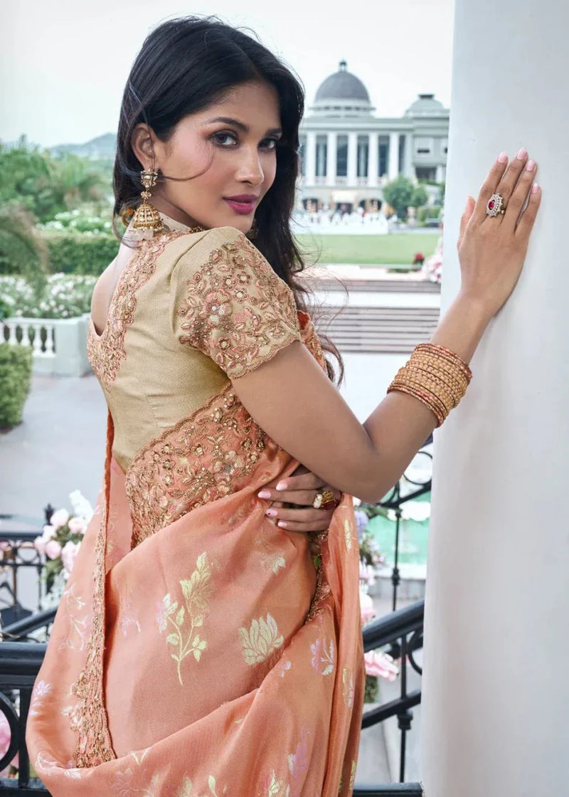 Coral peach saree with gold floral embroidery and ornate beaded border, blouse visible