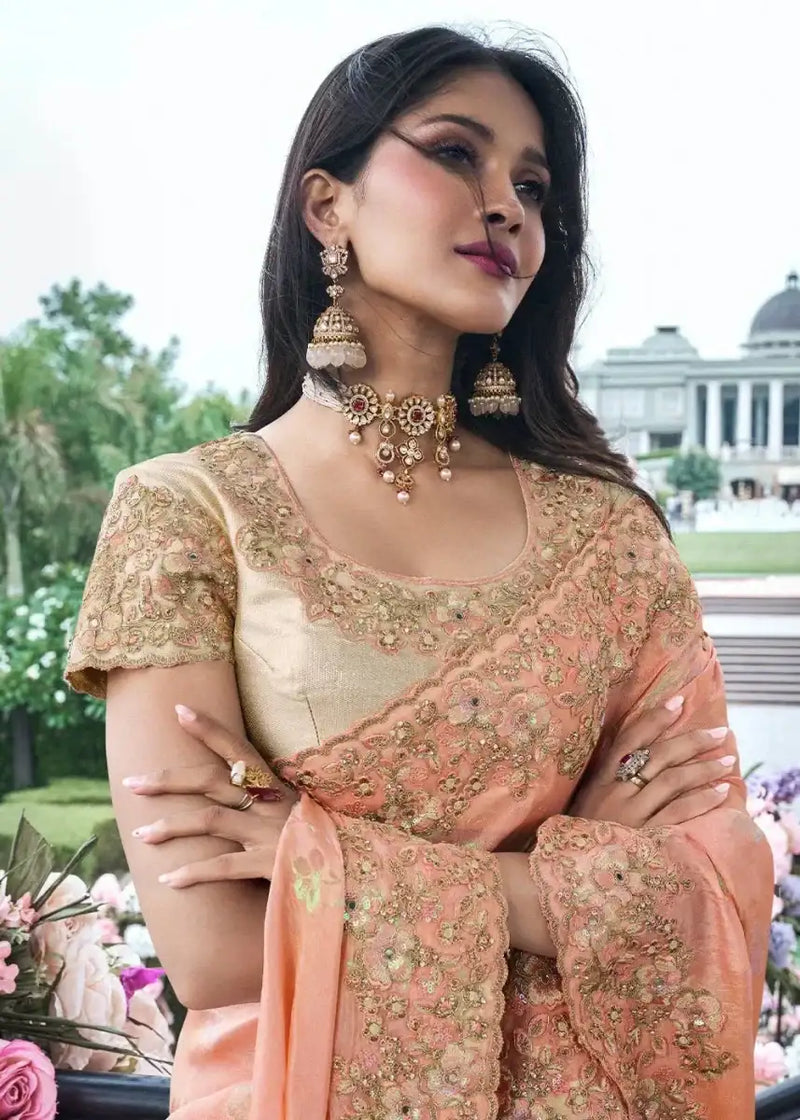 Coral peach tissue silk saree with gold floral embroidery, short sleeve blouse and neckline