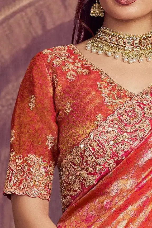 Metallic coral pink Kanjivaram silk saree with gold floral embroidery and beaded neckline