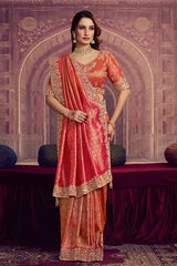 Coral pink Kanjivaram silk saree with gold jacquard motifs and scalloped lace border