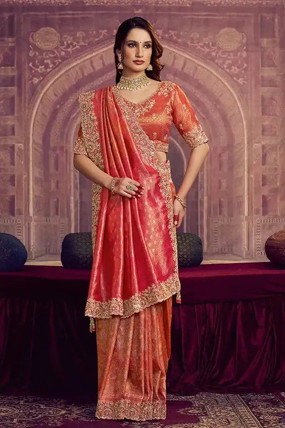 Metallic coral pink Kanjivaram silk saree with gold V-neck blouse and ornate hem border