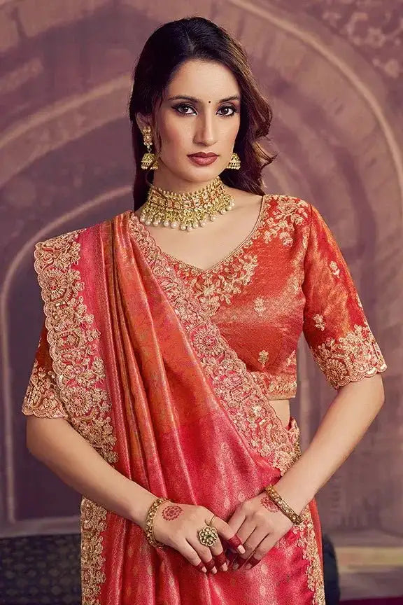 Metallic coral pink Kanjivaram silk saree with gold embroidered neckline and three-quarter sleeves