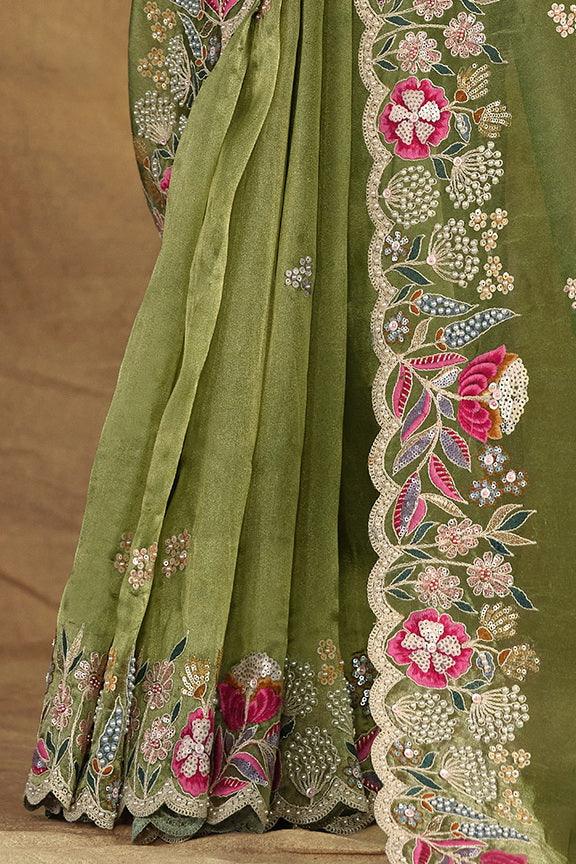 Green saree skirt with floral embroidered border and beadwork at the hem