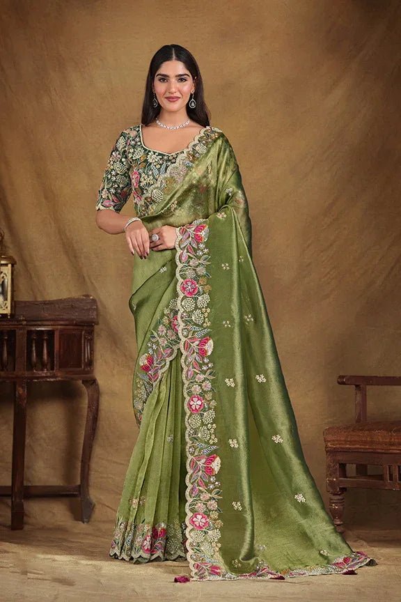 Metallic green saree with floral embroidery and embellished border, worn with belt