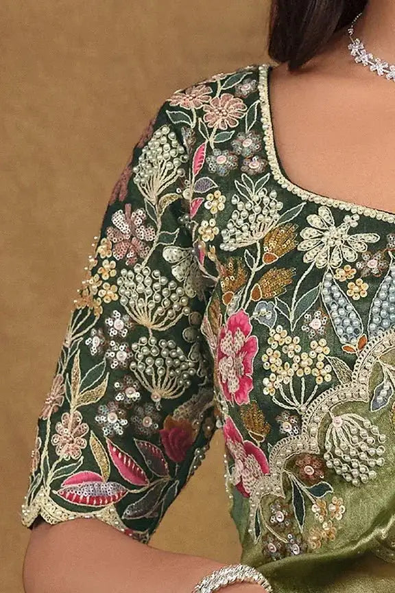 Green saree with floral embroidered blouse sleeves and beadwork neckline