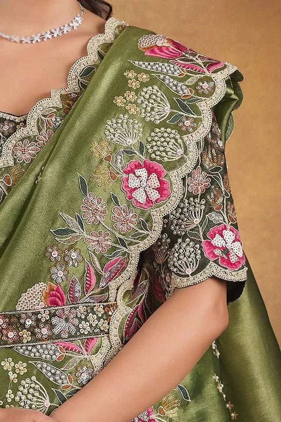 Green saree close-up with floral beadwork and embroidered border detail