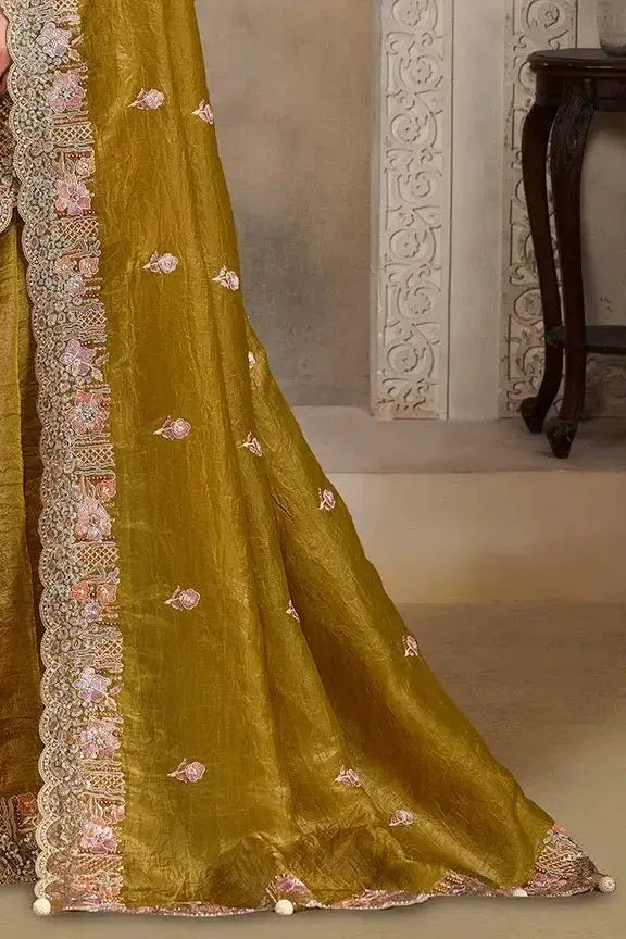 Olive-gold saree hem with scattered floral motifs and scalloped metallic border