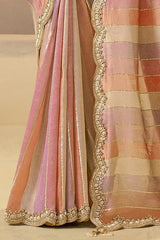 Pastel striped silk saree draped with metallic gold scalloped hem border