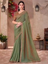 Sage green georgette saree with bronze-gold embroidered border and drape