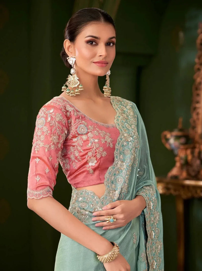 Embroidered pink blouse with sky blue saree drape, three-quarter sleeves and gold details