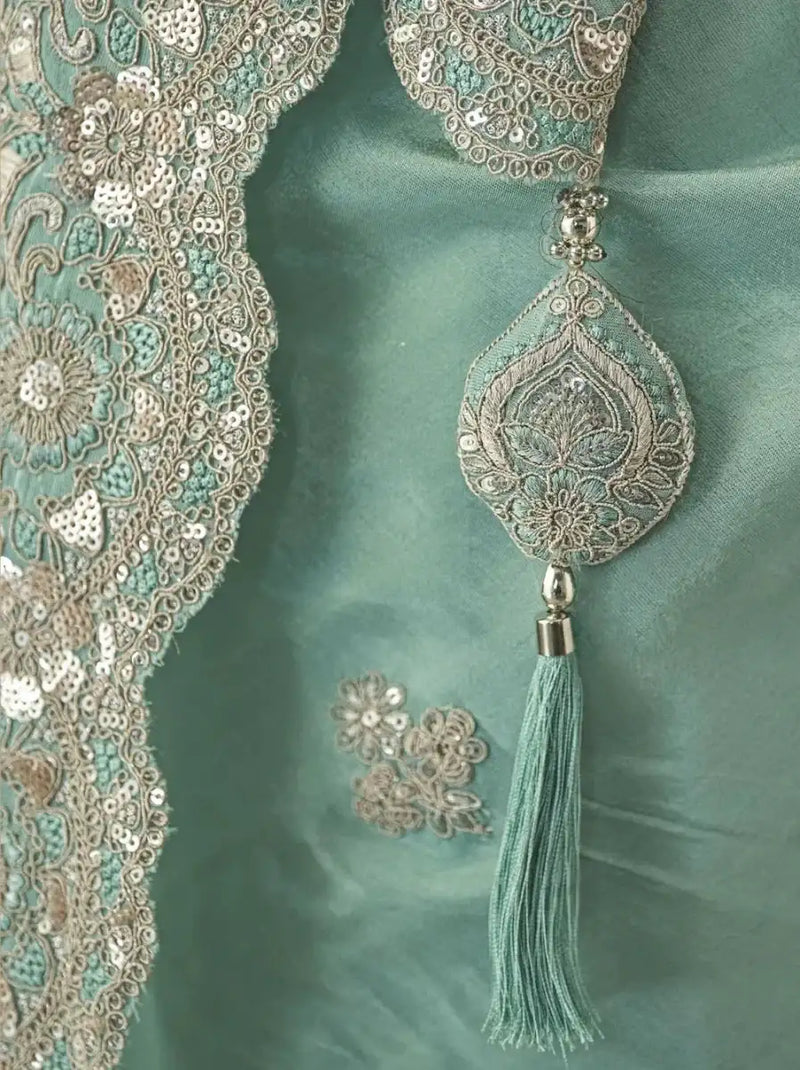 Sky blue blouse neckline with gold floral embroidery and tassel trim