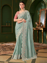Sky blue georgette saree with pink blouse, gold-toned floral embroidery and draped pallu